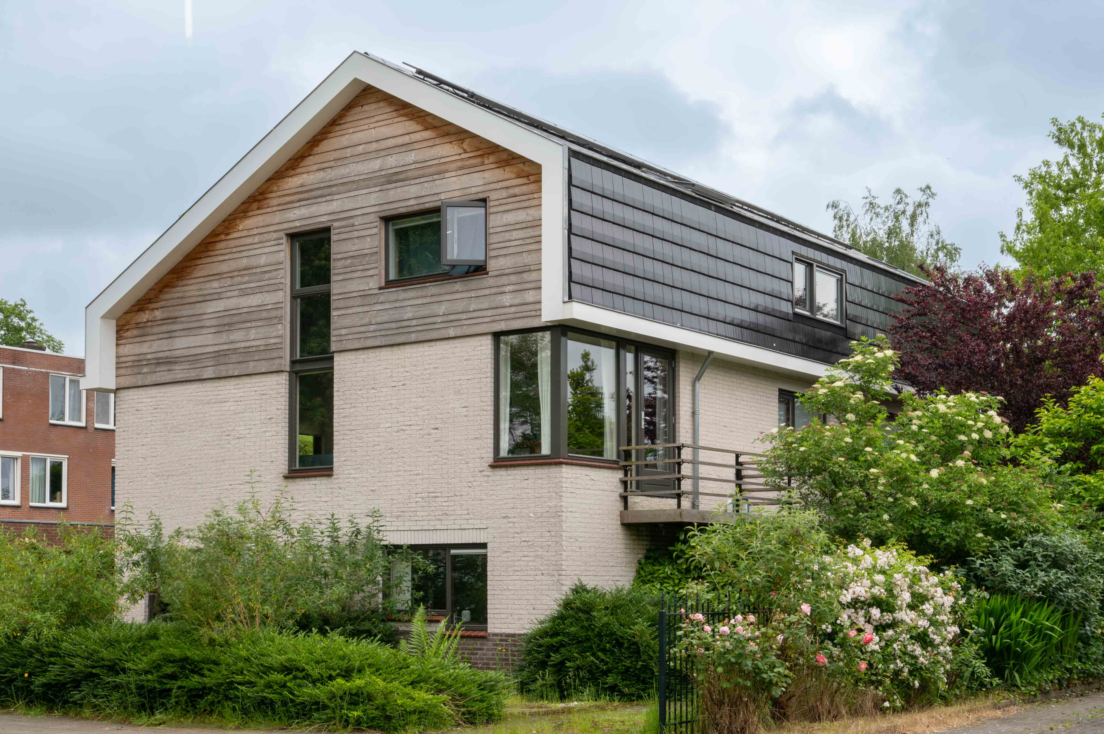 voor- en zijkant van een vrijstaand huis dat door bouwbedrijf w bouw gerenoveerd is